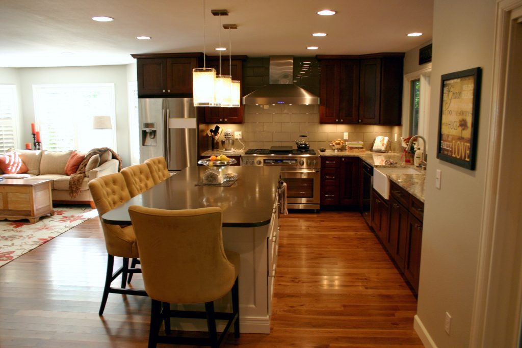 Kitchen renovation with large center island and plush chairs