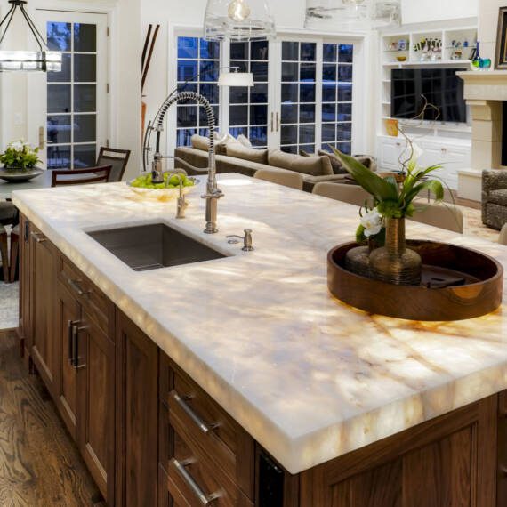 Remodeled kitchen with white Shaker cabinets and underlit countertops