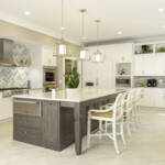 Kitchen with cream painted cabinets and dark wood island